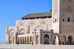 The minaret of the Hassan II Mosque in Casablanca under a blue sky
