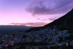 View over the blue city of Chefchaouen and the Rif mountains at dusk