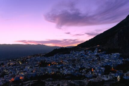 View over the blue city of Chefchaouen and the Rif mountains at dusk