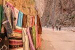 Colourful Berber scarves for sale below the gorge cliffs near Tinghir