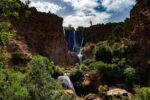The Ouzoud Waterfalls dropping into a green gorge